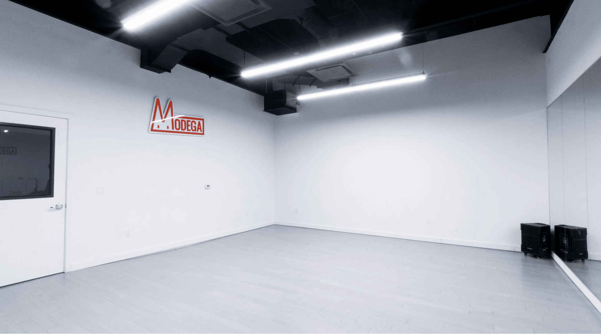 Dance studio without the Modega Logo hanging in the back of the room