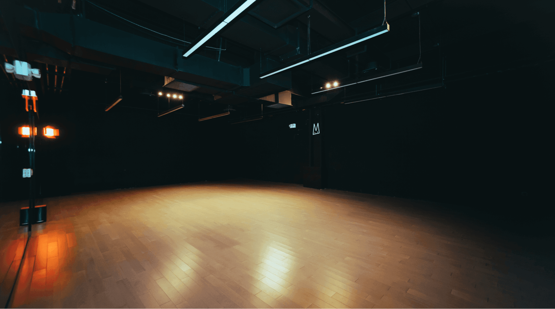 Large dance studio with dimmed overhead lights