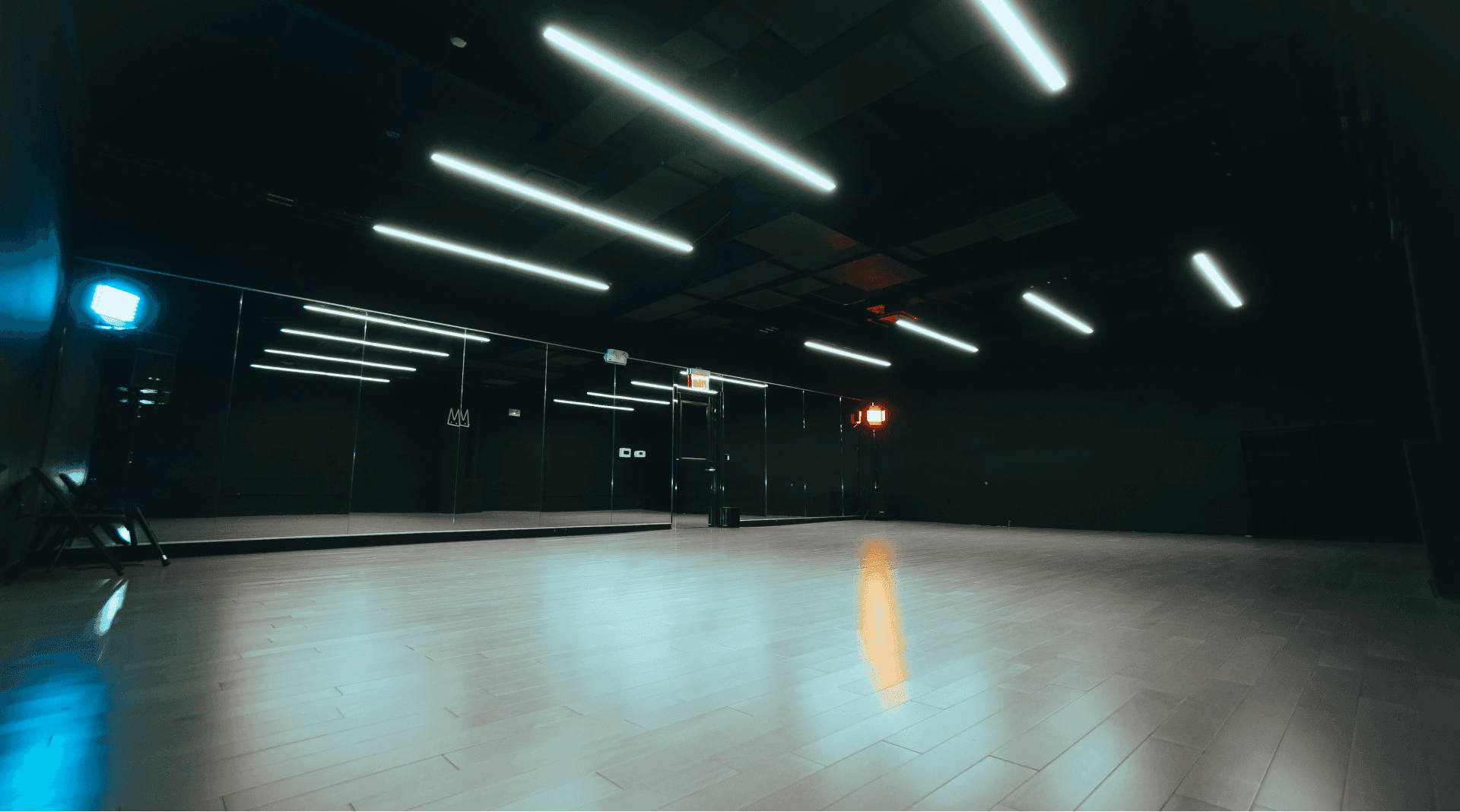 Large dance studio with spotlights, highlighting the sprung wood dance floor