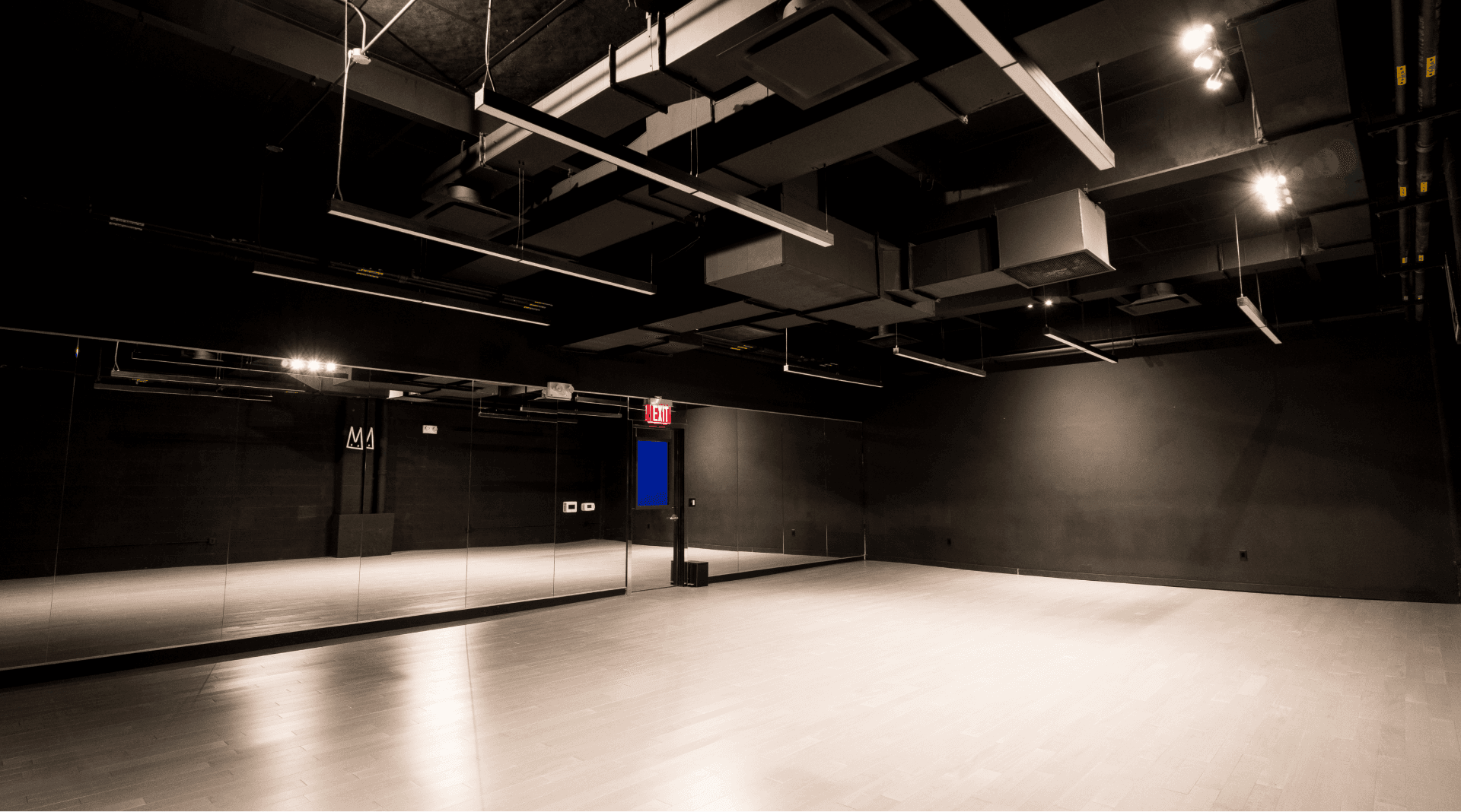 Large dance studio with bright overhead lights